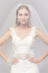 Modern minimalist bride wearing a sheer fingertip length blusher veil over her face. Annastacia Fingertip Veil by Laura Jayne Accessories Toronto. Handcrafted in Canada.