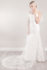 Modern bride wearing a sheer cathedral length wedding veil with floral French Alencon lace trim. Sakura Lace Cathedral Veil. Laura Jayne Accessories Toronto. Handcrafted in Canada.