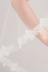 Close up of mantilla veil border with French wild rose and leaf floral lace edging. Hayley Fingertip Alencon Mantilla Veil by Laura Jayne. Handcrafted in Canada.