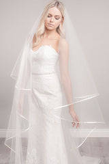 Bride looking down wearing ribbon edge cathedral veil Miranda by Laura Jayne Accessories Toronto. Handcrafted in Canada.