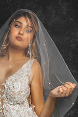 Bride with pearl beaded blusher veil over face Alayna by Laura Jayne Accessories