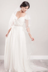 Portrait of bride looking down wearing embroidered chapel veil Sydney by Laura Jayne