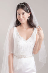 Waist up portrait of modern bride wearing two tier Leanna Crystal Edge Chapel Veil by Laura Jayne Associates Toronto. Handcrafted in Canada.