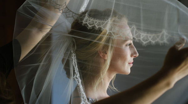 bride putting on a veil 