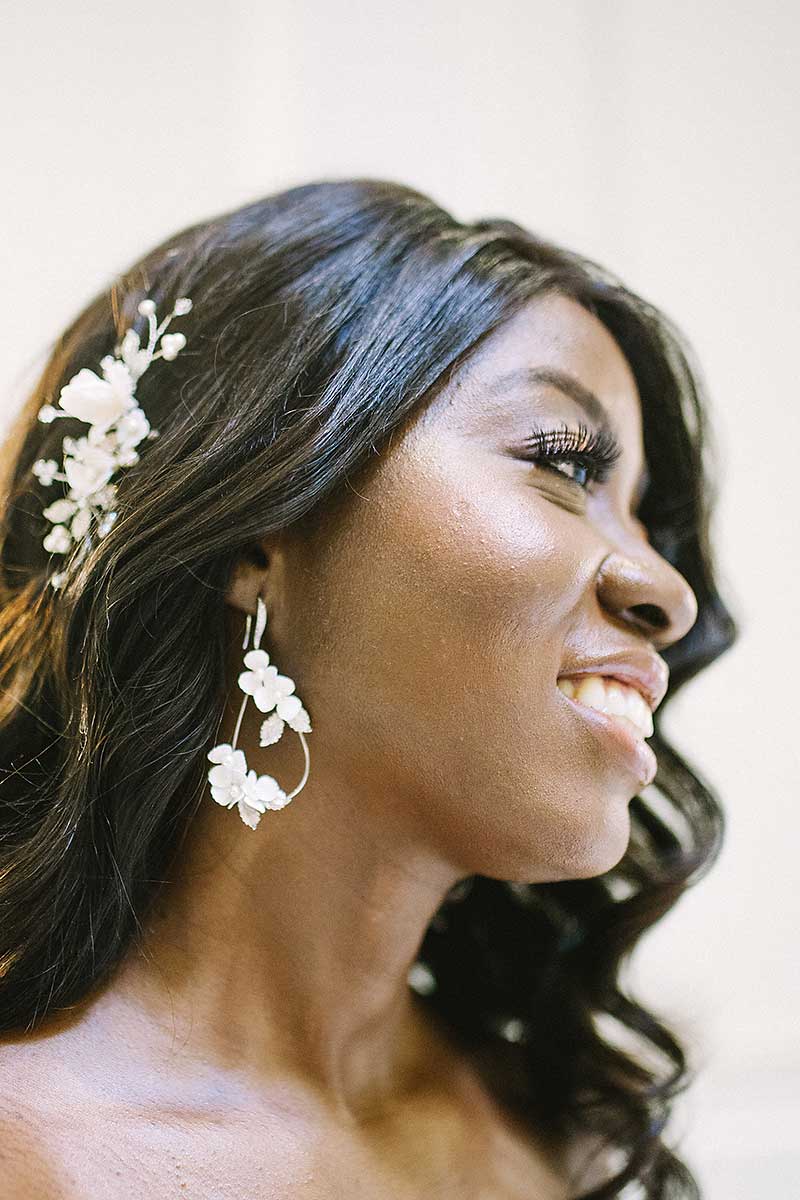 profile of woman wearing Laura Jayne floral tear drop hoop earrings and floral hair comb