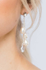 close up of modern pearl crystal chain drop earrings in woman's ear