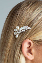 Close up of opal crystal and pearl comb Dusk by Laura Jayne Accessories tucked behind woman's ear