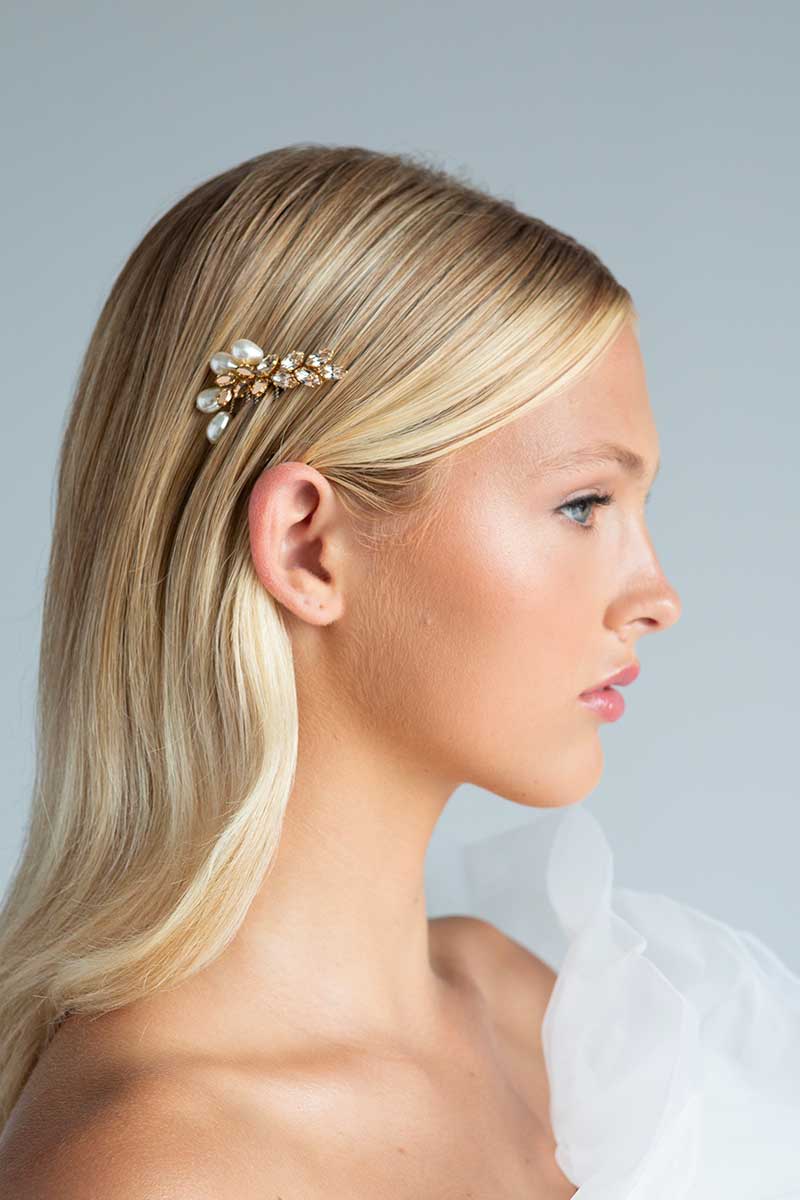 Profile of head and shoulders of woman with rose gold blush pearl hair comb Dusk by Laura Jayne Accessories tucked behind her ear