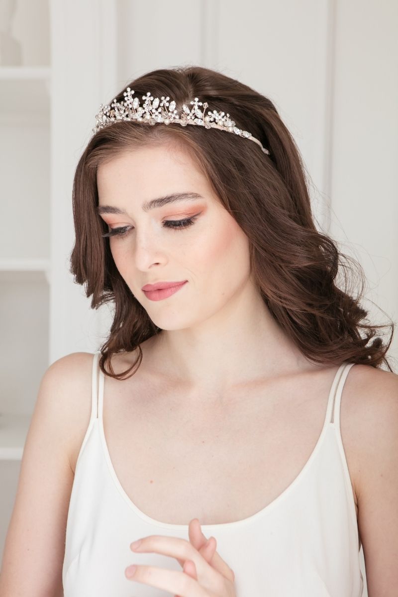Whimsical bride wearing a modern floral bridal crown with cream pearls, clear and smoked crystals. Shown in rose gold. Gold and silver also available. Adrienne Tiara by Laura Jayne. Handcrafted in Toronto, Canada. 