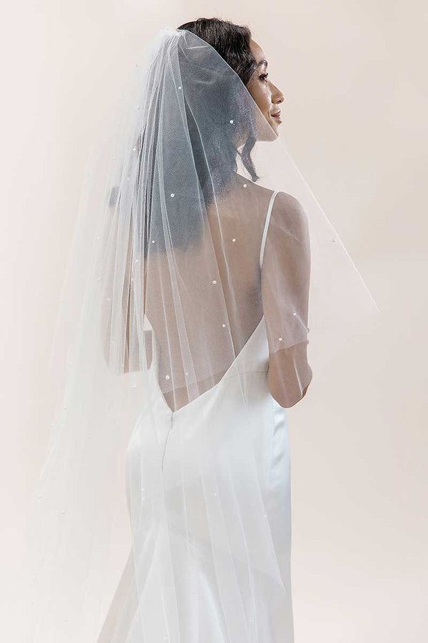 Profile of modern romantic bride wearing pearl cathedral length drop veil. Alayna Pearl Cathedral Veil. Laura Jayne Accessories Toronto. Handcrafted in Canada.