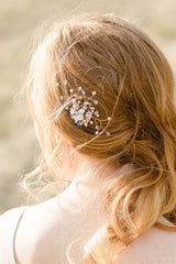 back of woman's head with Laura Jayne Louise gold wired floral comb