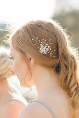 profile of woman wearing small gold flower haircomb