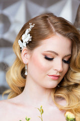 Woman wearing Giordana bridal hair comb tucked at the profile into glam waves