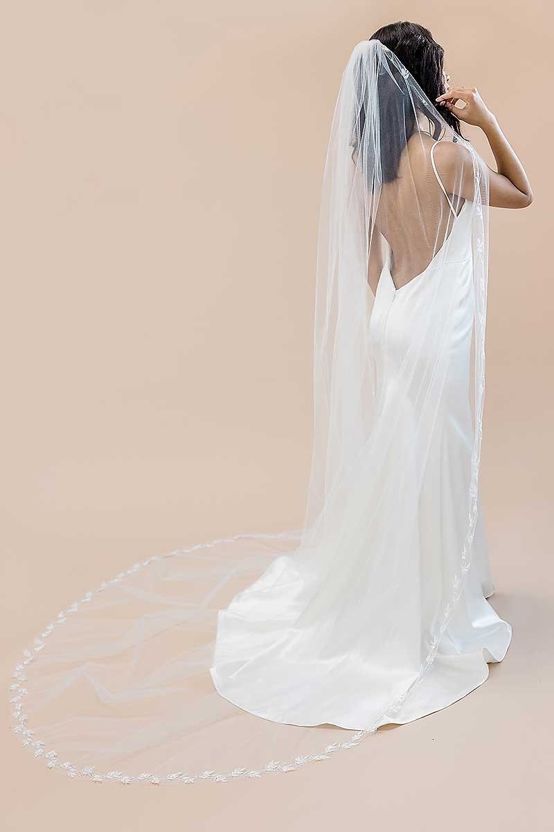Back view portrait of bride wearing cathedral veil with nature-inspired leaf embroidery Laurella VE8007 by Laura Jayne Accessories