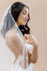 Profile of bride from waist up wearing Laurella cathedral wedding veil with leaf embroidery by Laura Jayne Accessories