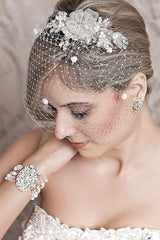 Side profile of bride wearing Celeste flower hair comb with birdcage veil. Laura Jayne Accessories Toronto. Handcrafted in Canada.