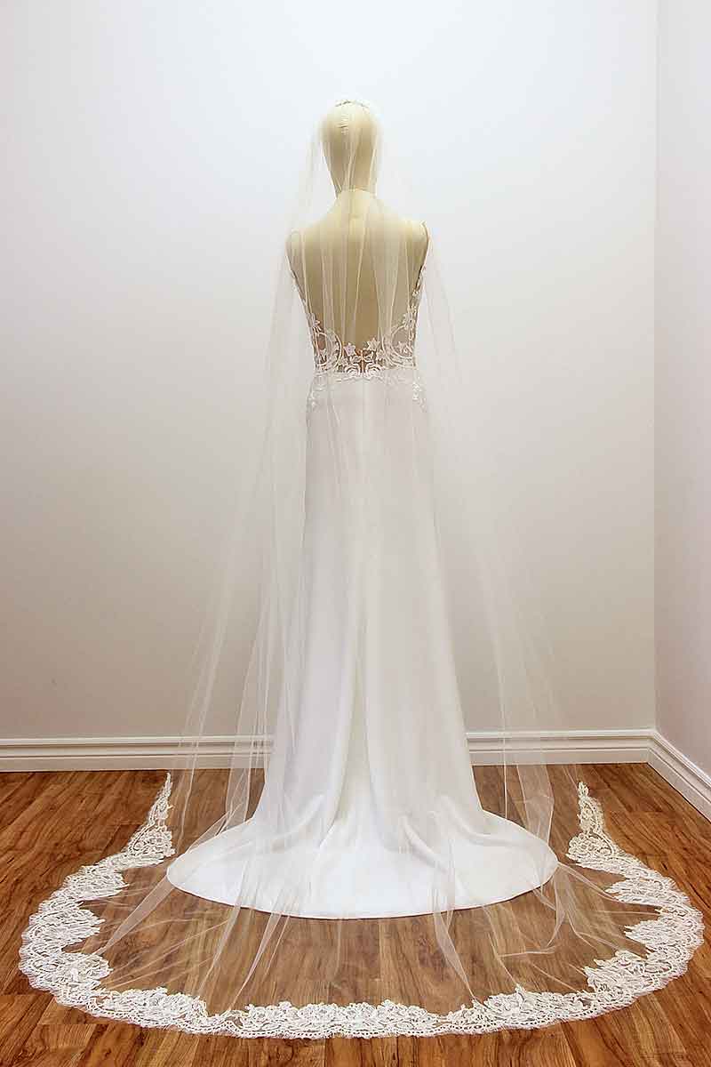 Make a statement, with this cathedral wedding veil featuring a train framed in a rich pattern of rose genuine French Alencon lace. Sheer light illusion flows effortlessly into the bold statement train to add a timeless modern sensuality to your w-day look