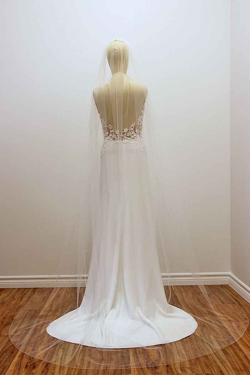 Full length back view of sheer illusion tulle cathedral wedding veil on mannequin. Cherish Crystal Cathedral Veil made in Canada by Laura Jayne Accessories Toronto.