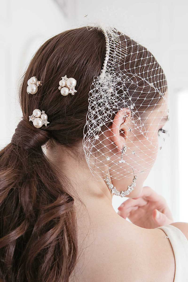 Profile of woman wearing Laura Jayne Nova pearl crystal star celestial wedding hairpin set