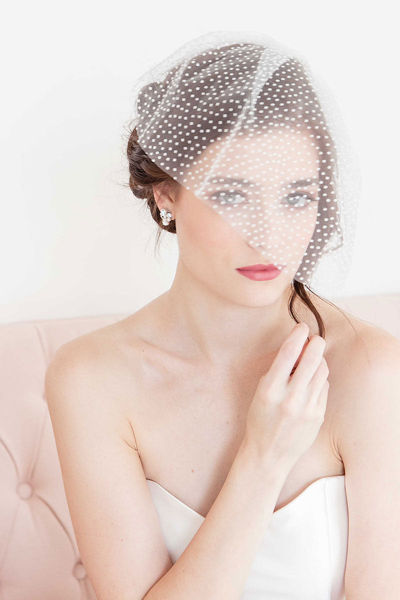 Bride wearing pearl, crystal and silver stud earrings. Bridal jewelry handmade in Canada. 