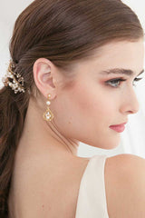 Profile of woman wearing pearl gold and champagne crystal bridal earrings. 