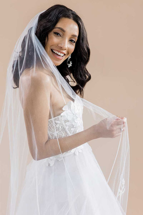Modern romantic bride wearing a long, sheer, cathedral length wedding veil with beaded flower blossoms. Monet Beaded Blossom Cathedral Veil by Laura Jayne Accessories Toronto. Made in Canada. 