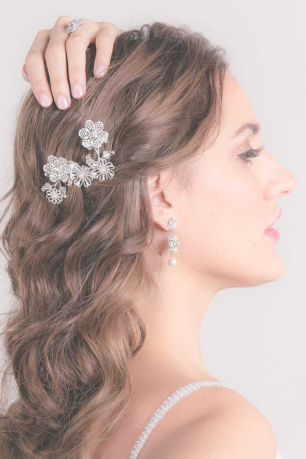 Profile of woman wearing flower blossom enameled wedding comb by Laura Jayne