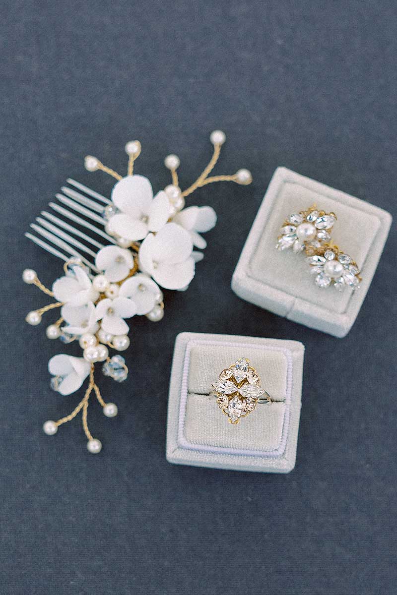 Wedding details flatlay with Laura Jayne earrings ring and Belinda clay flower comb