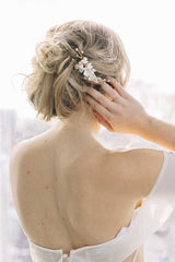 Backview of woman's head and shoulders wearing Laura Jayne Belinda clay flower comb 