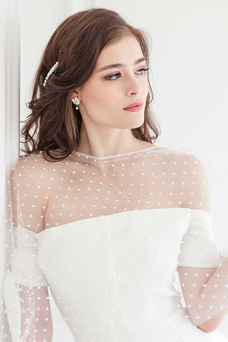 Bride looking to side wearing dot capelet and crystal pearl drop earrings E9081 by Laura Jayne Accessories