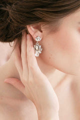Profile of woman with hand on neck wearing opal pear filigree statement earrings E9084 by Laura Jayne Accessories