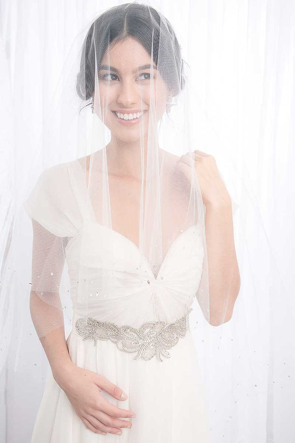 Woman wearing blusher veil and Estelle wedding sash by Laura Jayne Accessories