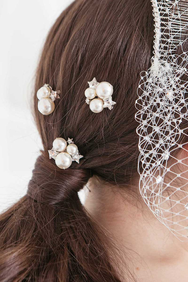 Back of womans head wearing pearl crystal star wedding hairpins Nova by Laura Jayne Accessories