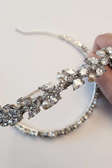 Close up of Laura Jayne Helena CZ pearl headband in womans hand