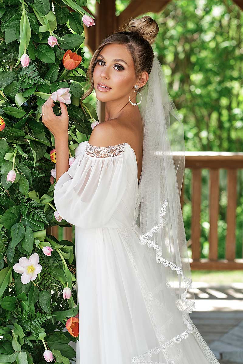 Profile of a boho chic bride wearing a romantic fingertip length bridal veil with embroidered scallop lace trim. Julia Fingertip Venise Lace Veil by Laura Jayne Accessories Toronto. Handmade in Canada.