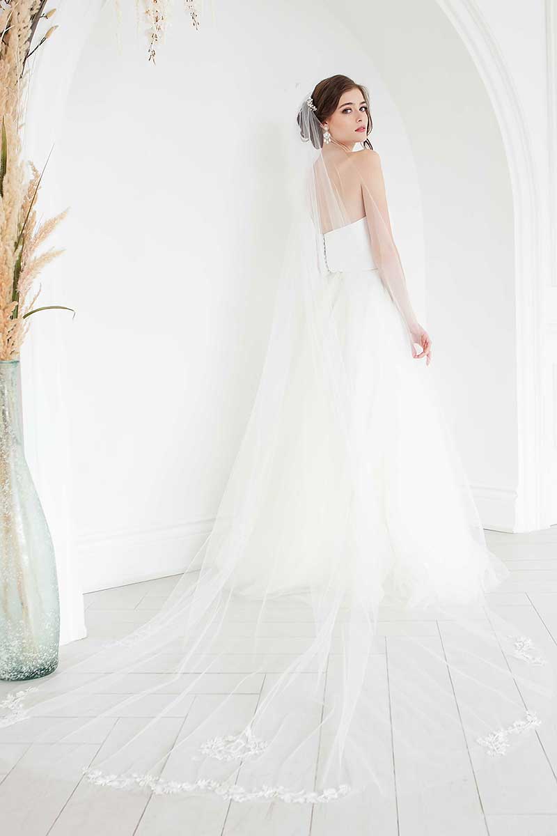 Back view of bride wearing statement cathedral veil with wildflower inspired floral monogram crest by Laura Jayne Accessories Toronto. Handcrafted in Canada.