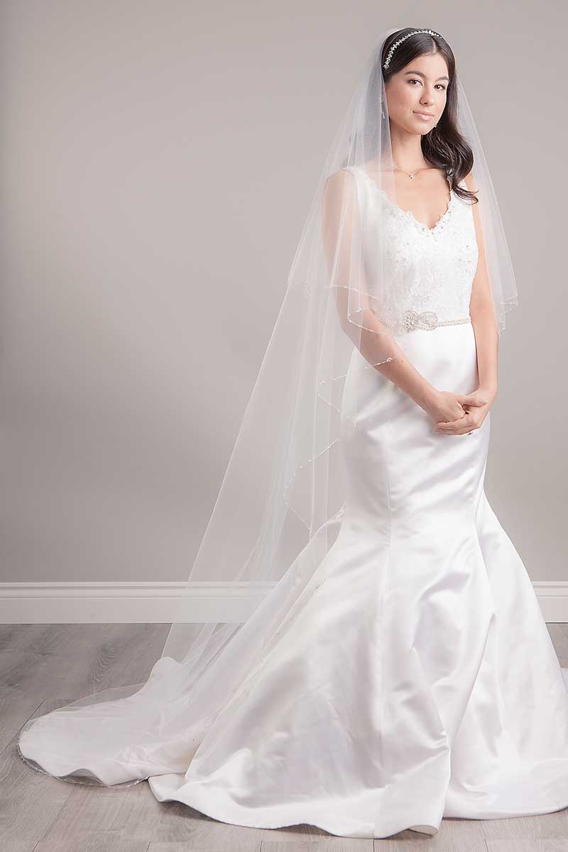 Portrait of bride wearing two tier Leanna Crystal Edge Chapel Veil by Laura Jayne Associates Toronto. Handcrafted in Canada.