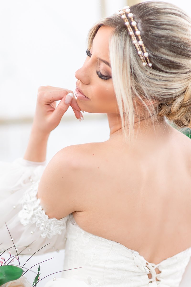 Profile of romantic modern bride wearing a stack of Laura Jayne skinny crystal bridal headbands with and without pearls including the Syren Pearl Crystal Headband. Handmade in Toronto, Canada.