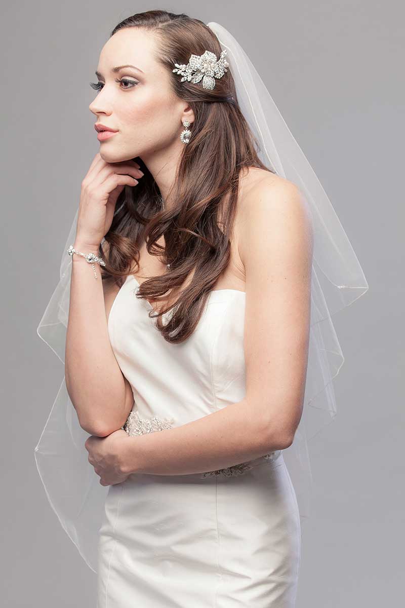 Modern romantic bride wearing Embrace Cascade Fingertip Veil by Laura Jayne Accessories Toronto. Handcrafted in Canada.