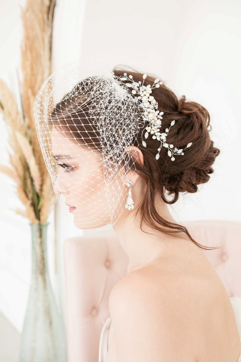 Modern romantic bride wearing a Laura Jayne Manon Birdcage Veil with a glamorous headpiece and bridal earrings. Veil, earrings and headpiece handcrafted by Laura Jayne Accessories Toronto. Handcrafted in Canada.