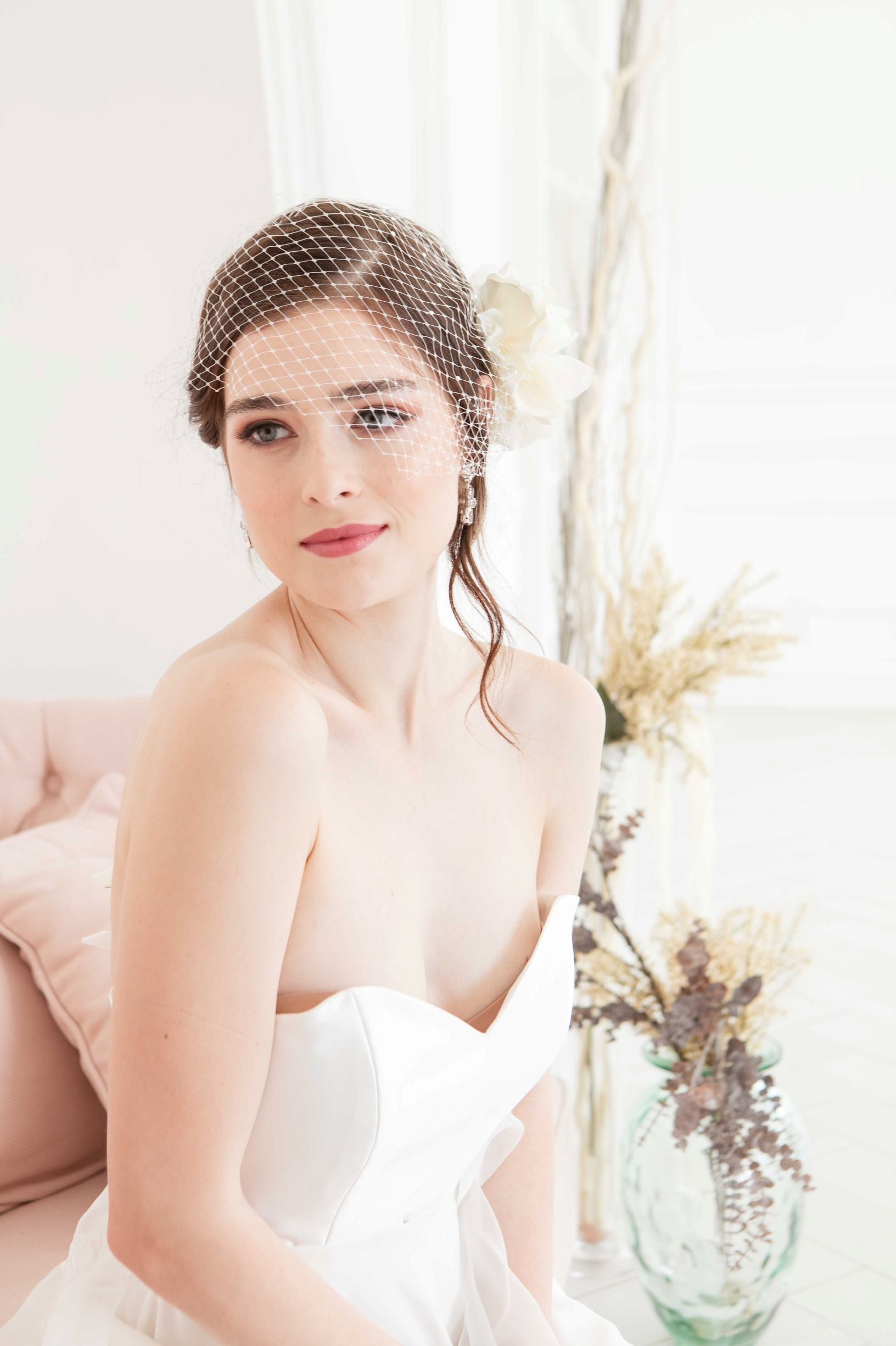 Modern contemporary bride wearing a timeless ivory colored birdcage veil by Laura Jayne. Manon Birdcage Veil. Handmade in Toronto, Canada.