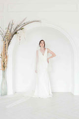 Full view of a bride wearing a minimalist ivory tulle two tiered circle cut veil. Marlow Cathedral Drop Veil. Handmade in Canada by Laura Jayne Accessories.