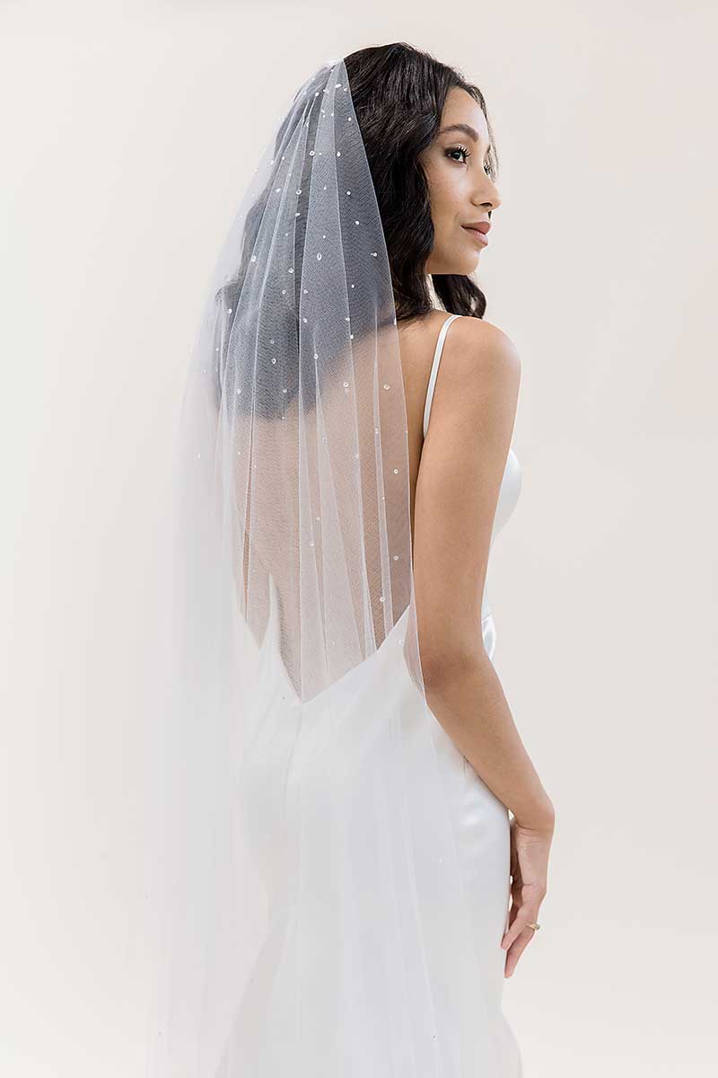 Side back view of bride wearing Rain crystal waltz length drop veil by Laura Jayne Accessories