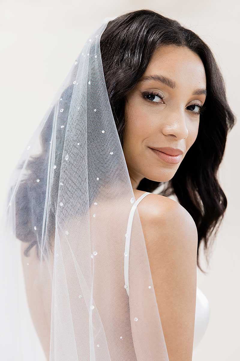 Head and shoulders of bride with close up detail of beading on Laura Jayne Rain crystal waltz length drop veil. Handcrafted in Toronto, Canada.
