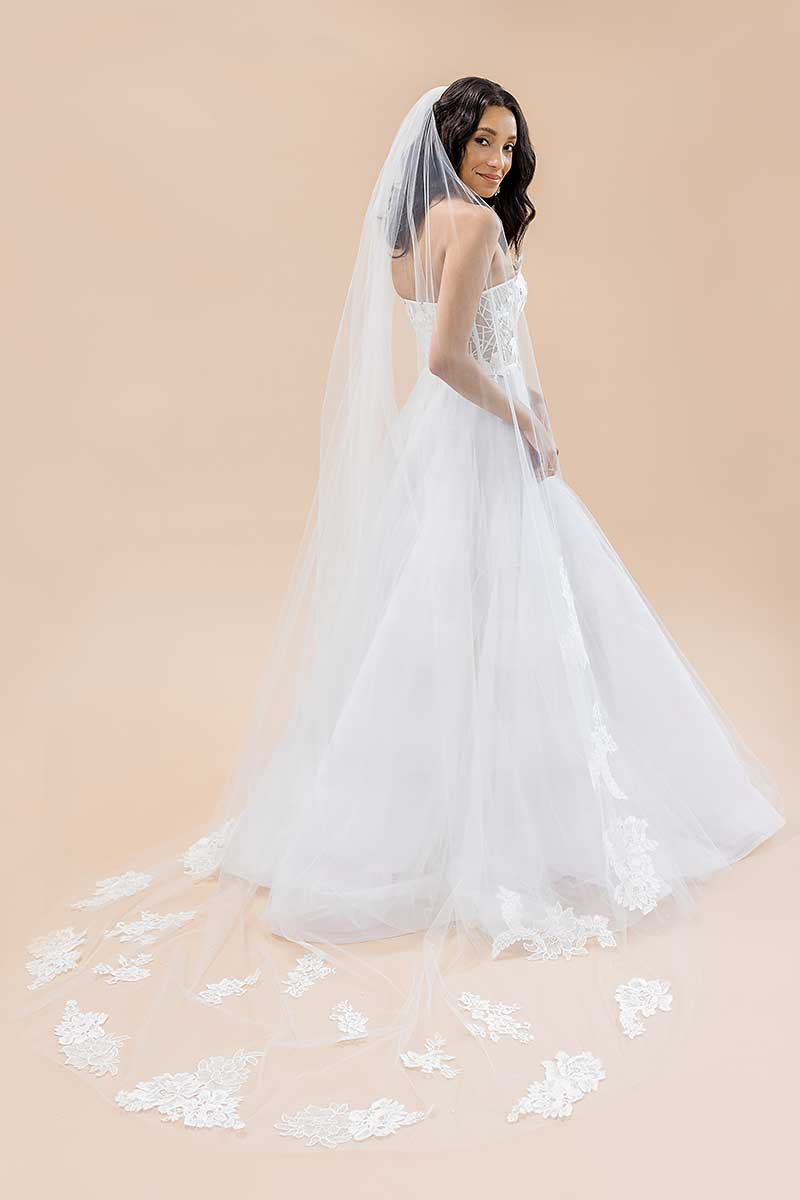 Portrait of bride wearing cathedral veil with statement French lace train Seine by Laura Jayne Accessories