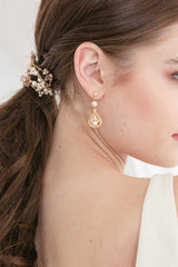 Woman profile with ponytail wrap and gold drop earring