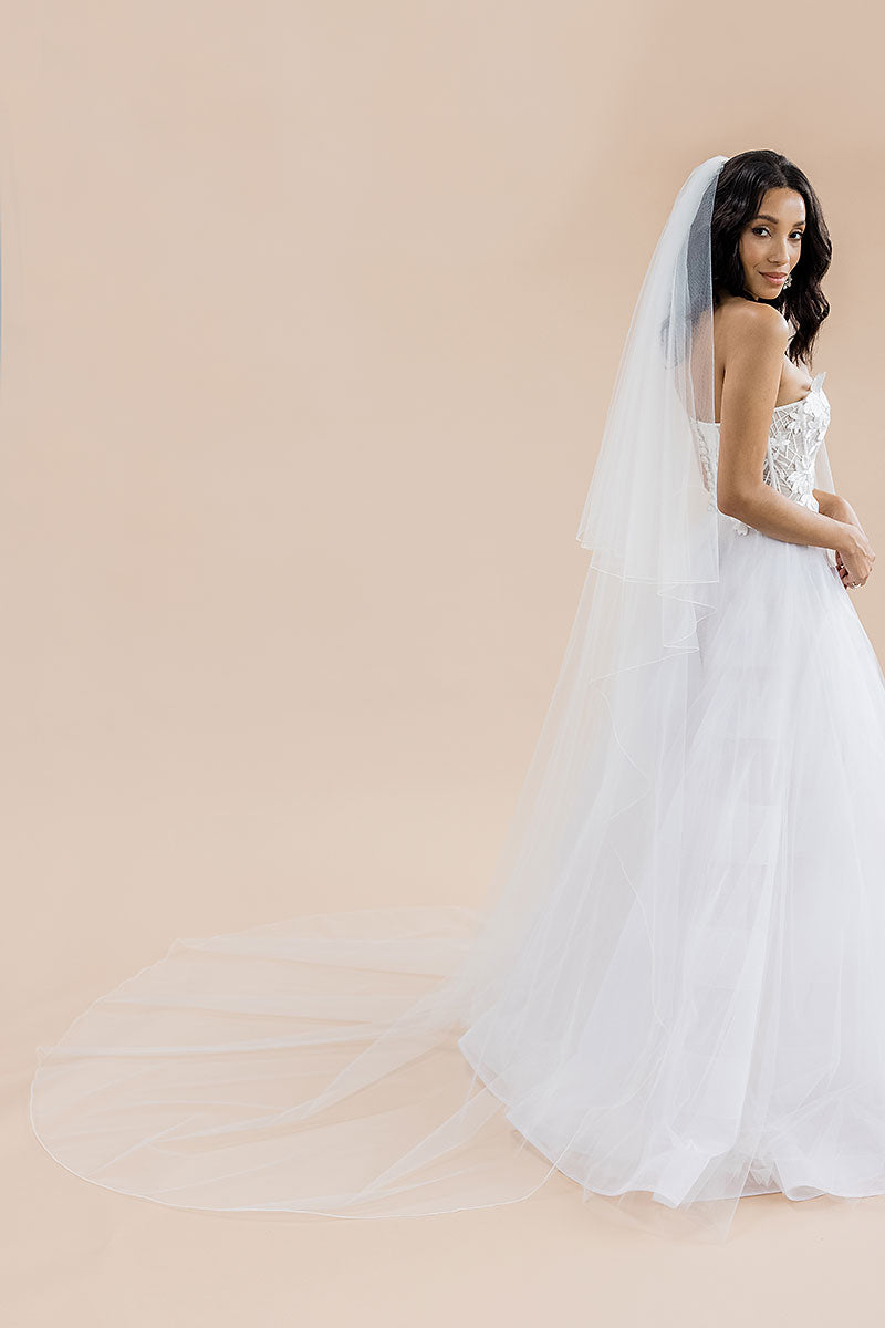 full profile of bride wearing two-tier cathedral pencil edge veil Rosalynda by Laura Jayne