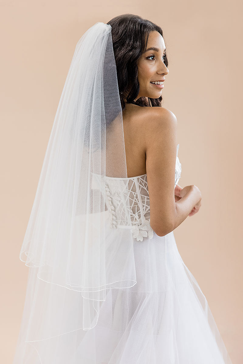 Profile of smiling bride wearing two tier cathedral wedding veil Rosalynda by Laura Jayne 
