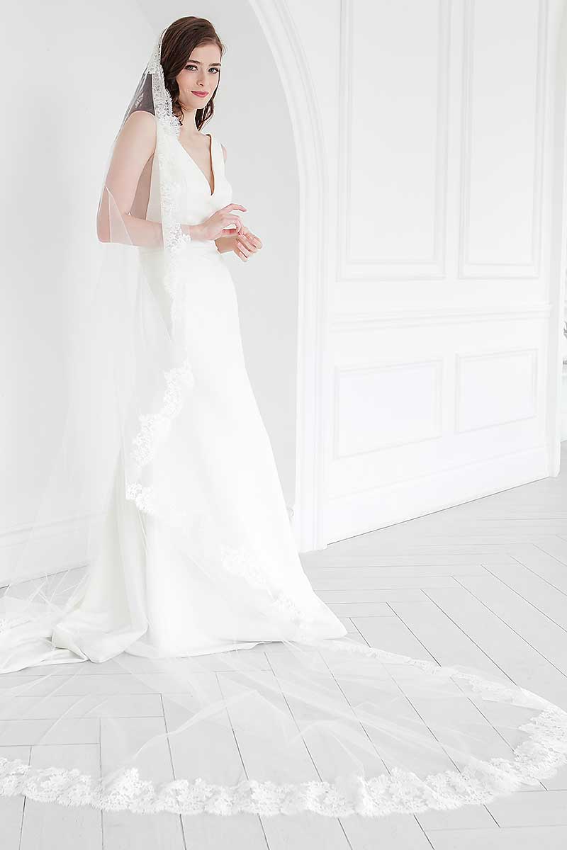 Off center view of the Peyton Mantilla Cathedral Veil's full train on bride.