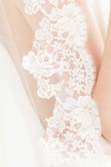 Closeup of Peyton Mantilla veil's border of French Chantilly lace in a timeless floral pattern.